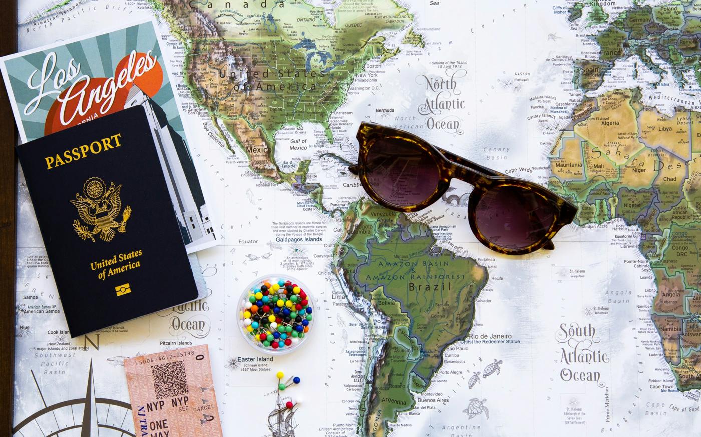 brown framed sunglasses on map by GeoJango Maps courtesy of Unsplash.
